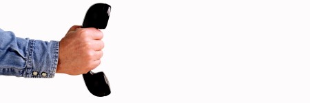 Hand Holding Telephone against a white background